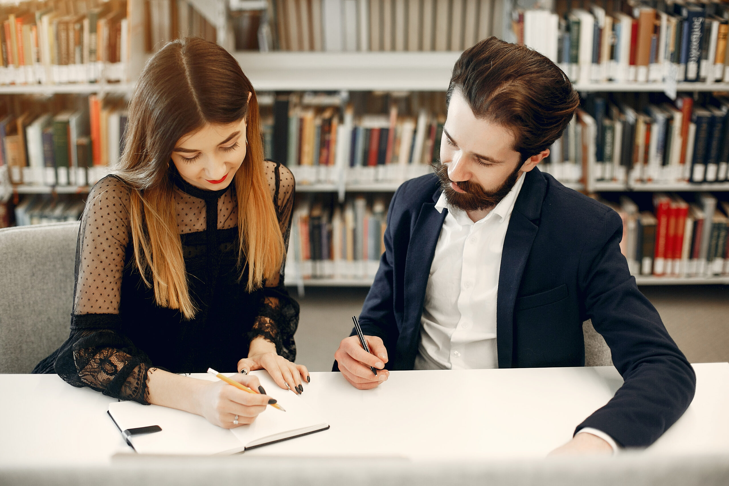 two students study at the library
